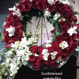 Heart-shaped wreath of red roses and white orchids