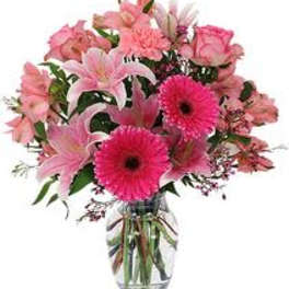 Pink mixed bouquet with lilies, roses, and gerbera daisies in a glass vase