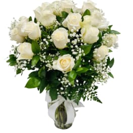 White rose bouquet in a glass vase with baby's breath