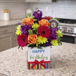 Birthday flower arrangement in a white gift box with roses and daisies