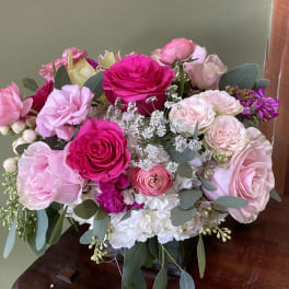 Pink and white rose bouquet with mixed blooms in a vase