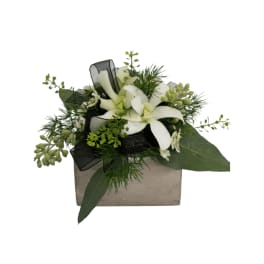 White floral arrangement in a square box with black ribbon