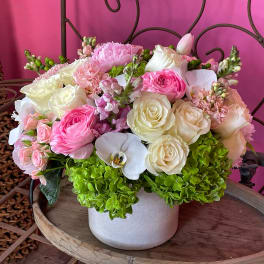 Pink and white flower arrangement in a white vase