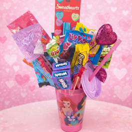 Candy bouquet in a pink cup with heart decorations