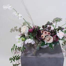 Low floral arrangement with white and blush blooms in a white bowl