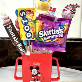 Mickey Mouse candy bouquet in a red container with assorted sweets on sticks