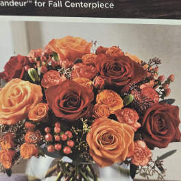 Bouquet of orange and red roses in a glass vase