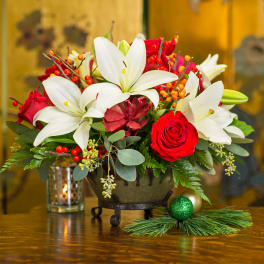 Bouquet of red roses and white lilies in a low bowl