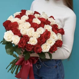 Bouquet of red and white roses tied with a red ribbon