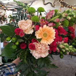 Bouquet of pink roses, peach carnations, and a peach gerbera daisy