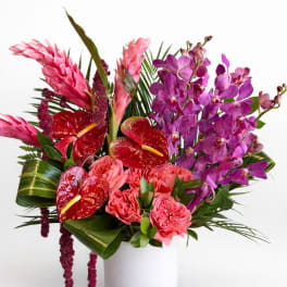 Pink and purple tropical bouquet in a white vase