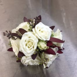 White rose bouquet with dark burgundy accents