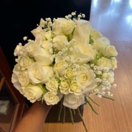 Bouquet of white roses and calla lilies with baby's breath