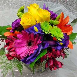 Colorful bouquet with yellow roses, gerbera daisies, and purple flowers