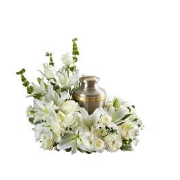 White lily and rose cremation urn wreath with a metal urn in the center
