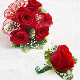 Red rose posy bouquet with matching single-rose boutonniere on a white surface