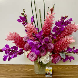 Pink and purple floral arrangement in a glass vase