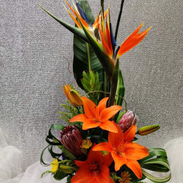 Tall tropical bouquet with orange lilies and bird of paradise