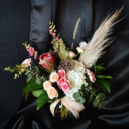Mixed bouquet in a black vase with pink and white flowers