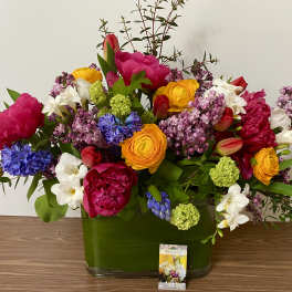 Colorful mixed bouquet in a green glass vase