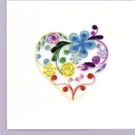 Greeting card with a rainbow quilled paper heart filled with stylized flowers on a white background