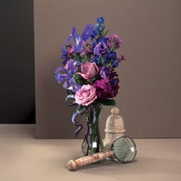 Bouquet of purple and pink flowers in a glass vase with a ribbon