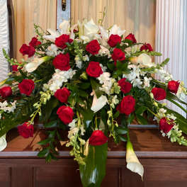 Large floral arrangement with red roses and white calla lilies