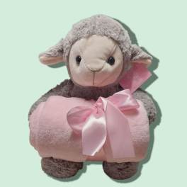 Plush lamb holding a pink blanket with a satin bow