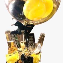 Balloon-topped gift arrangement with beer bottles and candy bars