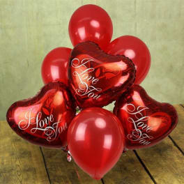 Red heart-shaped and round balloons with "I Love You" text