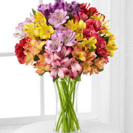 Bouquet of multicolored flowers in a clear glass vase