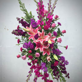 Tall floral spray with pink lilies and purple blooms