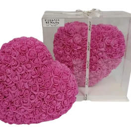 Heart-shaped arrangement of pink artificial roses with one displayed in a clear gift box