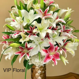 Bouquet of white and pink lilies in a gold vase
