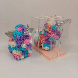 Pastel unicorn-shaped arrangement of artificial roses, one displayed inside a clear gift box.