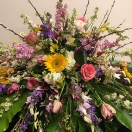 Large mixed floral spray with pink, purple, yellow, and white blooms