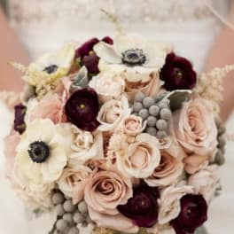 Bouquet of blush roses and dark burgundy flowers with white anemones