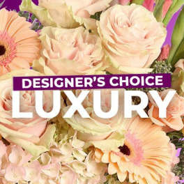 Pastel bouquet with roses and gerbera daisies, overlaid with "Designer’s Choice Luxury" text