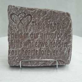 Engraved stone plaque with a heart design and memorial quote