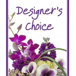 Designer’s Choice floral arrangement with purple orchids and white calla lilies