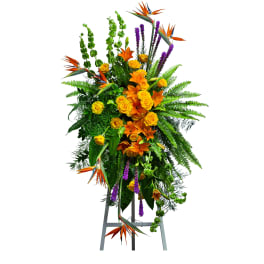 Tall floral standing spray with orange and yellow blooms on an easel