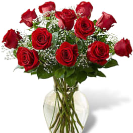 Red roses arranged in a clear glass vase