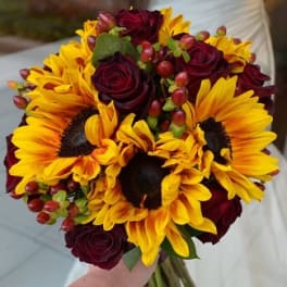 Bouquet of yellow sunflowers and deep red roses