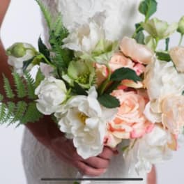 Bouquet of white and peach roses with greenery