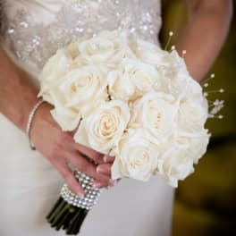 Bride holding a bouquet of white roses