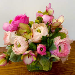 Pink and cream ranunculus bouquet in a glass vase
