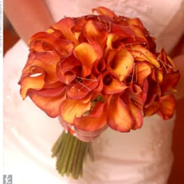 Orange calla lily bouquet with a wrapped stem bundle