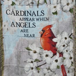 Decorative blanket with white flowers, a red cardinal, and the text "Cardinals appear when angels are near"