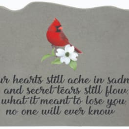 Gray memorial plaque with a red cardinal and white flower graphic