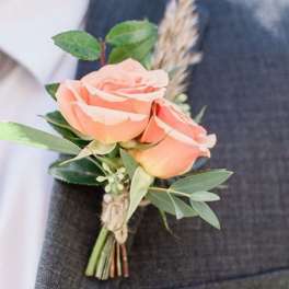 Peach rose boutonniere with greenery and twine wrap